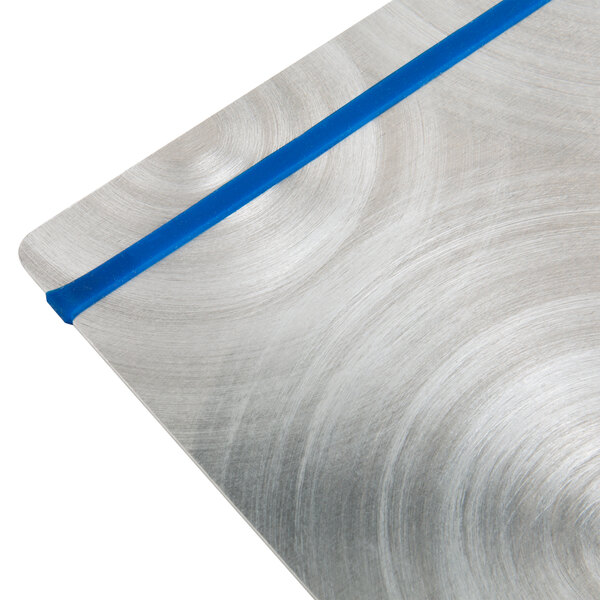 A Menu Solutions Alumitique aluminum menu board with navy bands on a table.