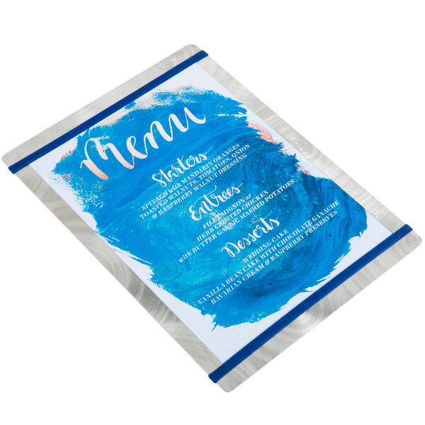 A white menu board with navy blue swirls on it.