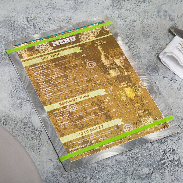 A Menu Solutions Alumitique aluminum menu board on a table.