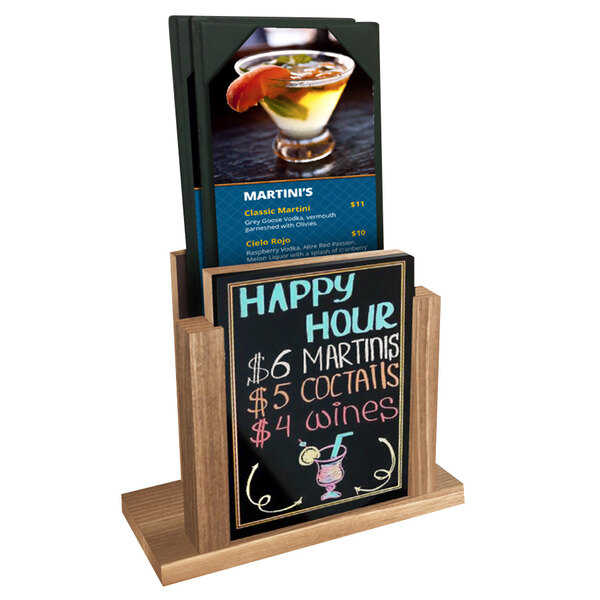 A Menu Solutions weathered walnut wood menu holder with a wet erase board on a table with a drink.