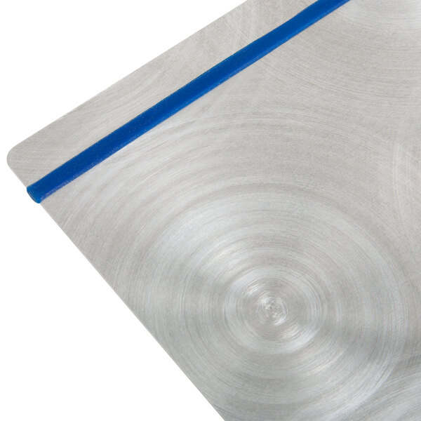 A silver aluminum Menu Solutions Alumitique menu board with navy blue bands on a metal table.