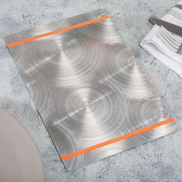 A Menu Solutions Alumitique menu board with orange bands on a table with a knife and fork.