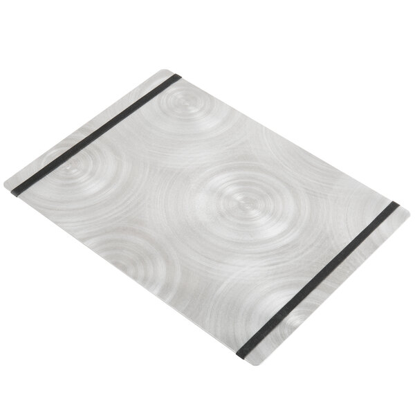 A silver Alumitique menu board with black swirls on a white table.