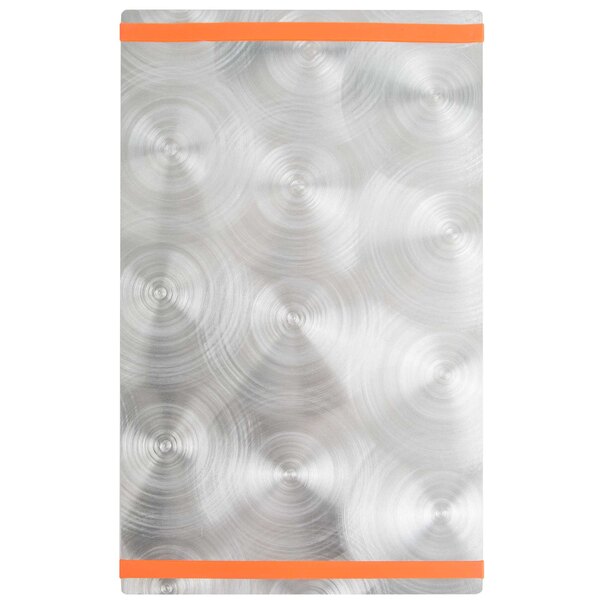 A silver rectangular Alumitique menu board with orange swirls on a metal surface.