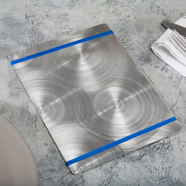 A Menu Solutions Alumitique aluminum menu board with royal blue bands on a table.
