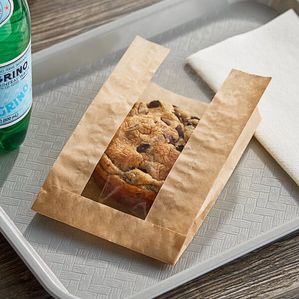 A cookie in a Bagcraft Packaging EcoCraft brown paper bag.