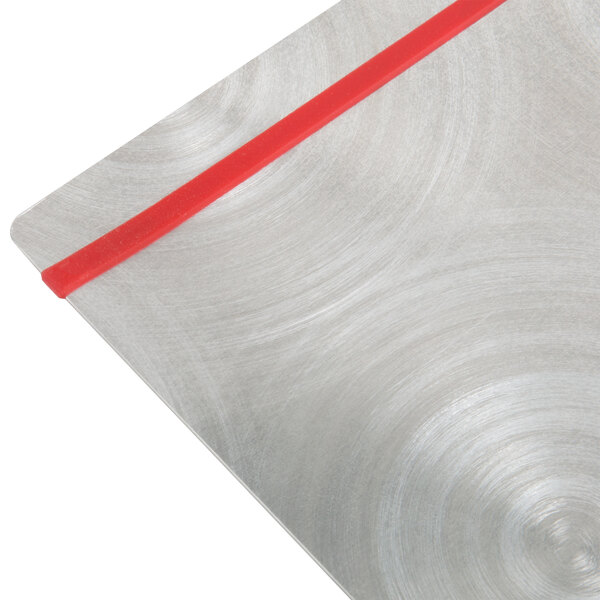 A Menu Solutions Alumitique aluminum menu board with red bands on a metal surface.
