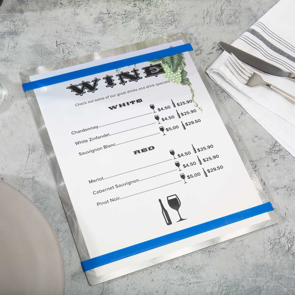 An Alumitique menu board with royal blue bands on a table with a knife and fork.