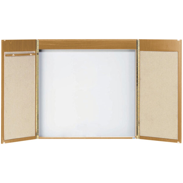 A wooden cabinet with a white rectangular whiteboard with a wooden frame.