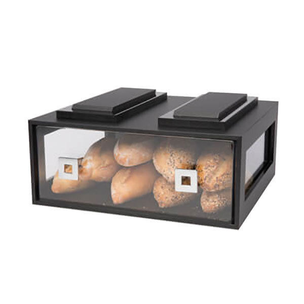 A black acrylic bakery building block drawer filled with bread on a counter.