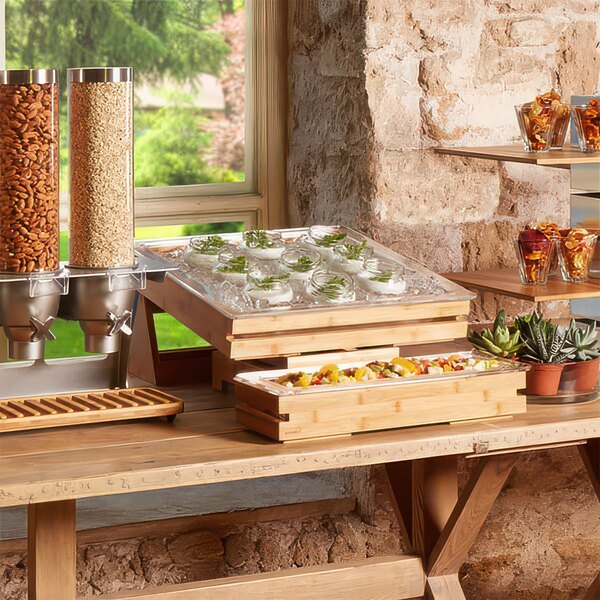 A wooden tray with food on a stand.