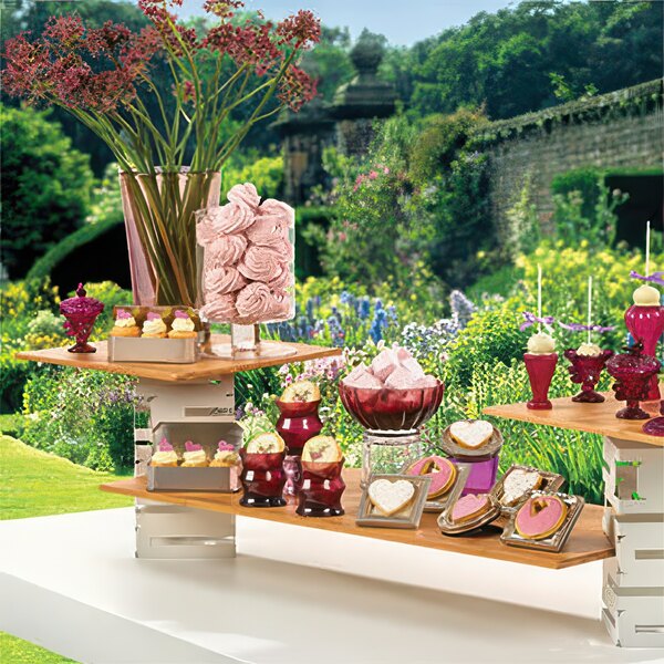 A table with a Rosseto square bamboo riser holding desserts.