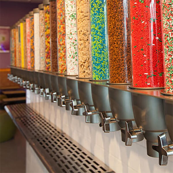 bright candy in a row of bulk food dispensers