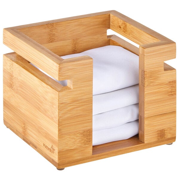 A Rosseto bamboo napkin holder with white folded napkins inside.