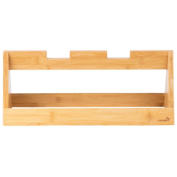 A natural bamboo tray riser with two shelves on a white background.