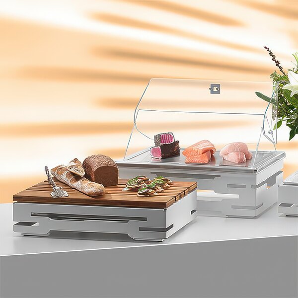 A Rosseto stainless steel rectangular display base with food in a glass display case.
