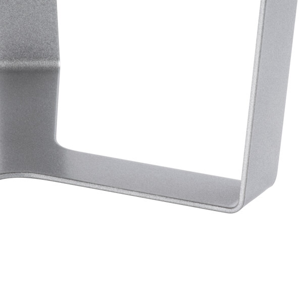 A white melamine round tray with a silver metal 3-leg riser.