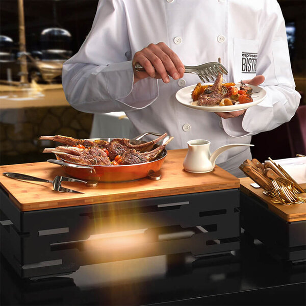 A chef using a Rosseto natural bamboo serving board to prepare food.