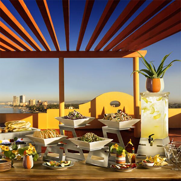 A table with food served in a Rosseto white porcelain square bowl.