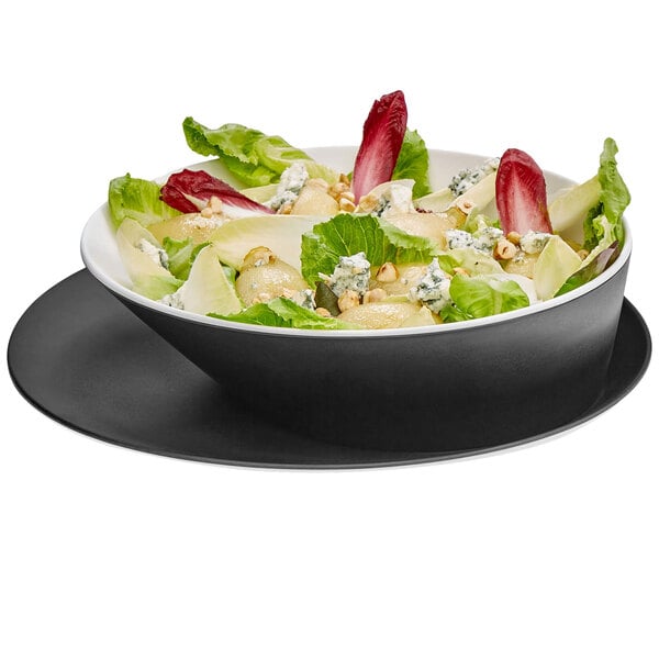 A black and white melamine tray with a bowl of salad on it.