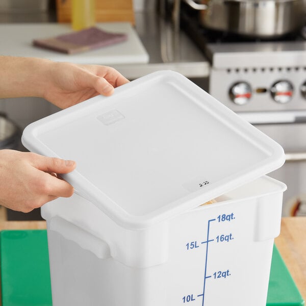 A person opening a white Choice polypropylene food storage container lid.