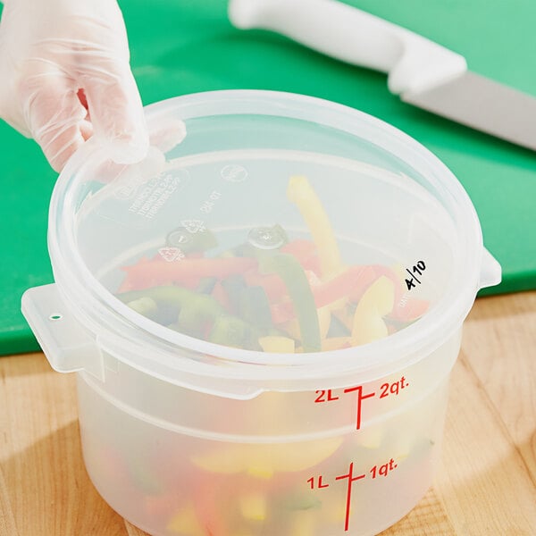 A translucent plastic lid on a Choice food storage container filled with food.