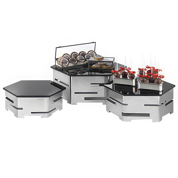 A Rosseto honeycomb riser shelf holding cookies and cakes on a buffet counter.