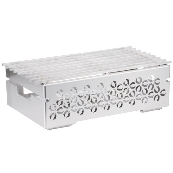 A white metal grill with a patterned design inside a white metal box.