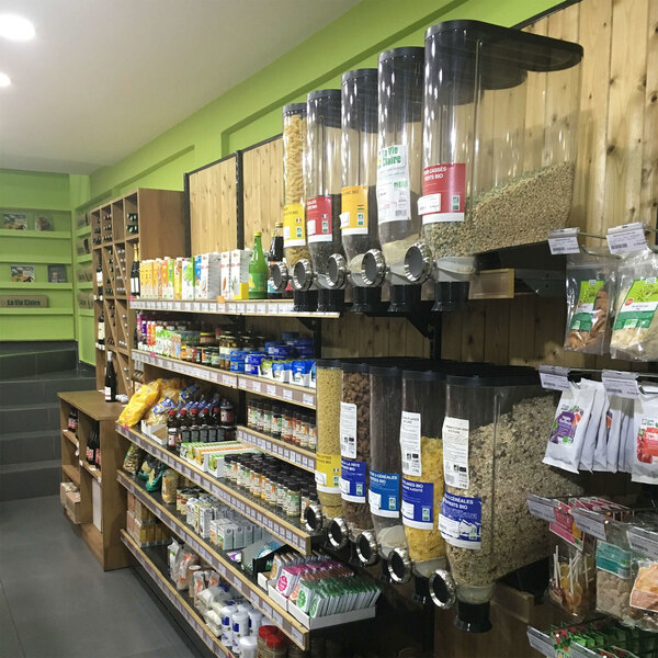 A Rosseto cereal dispenser on a shelf in a store filled with food.