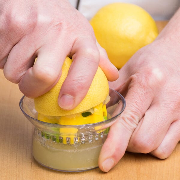 Chef using a reamer to juice a lemon