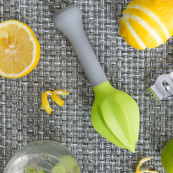 A Franmara plastic citrus reamer juicing a lemon.