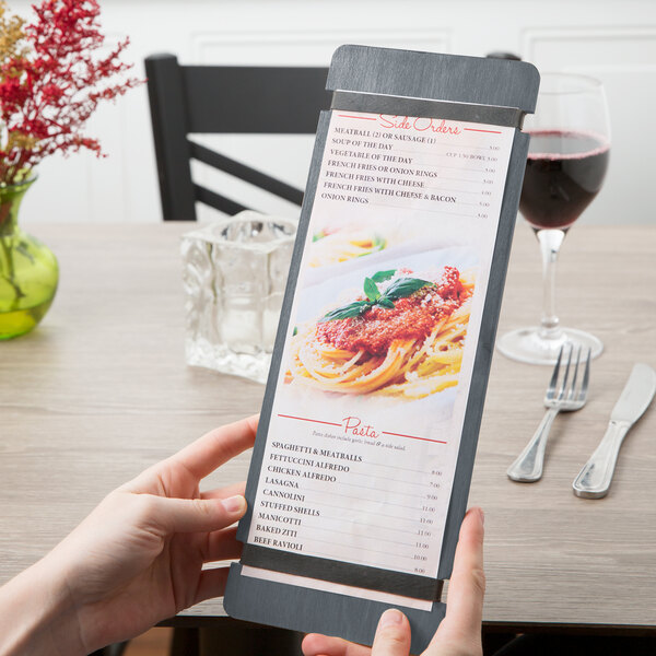 A person holding a Menu Solutions wood menu board with rubber bands.