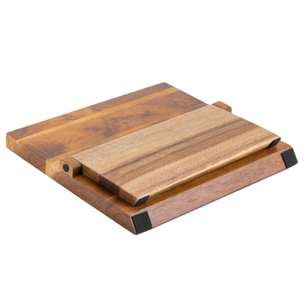 A Mercer Culinary Millennia® acacia wood magnetic board with a knife on it.