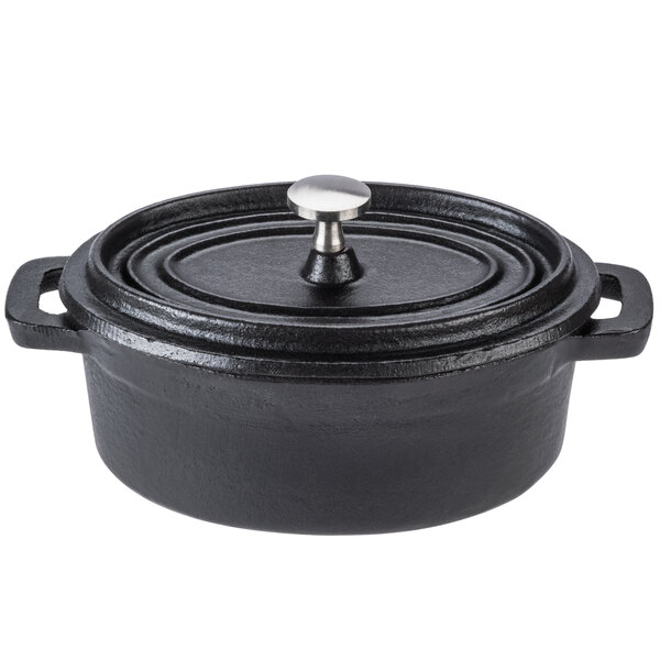 A case of 12 black cast iron Libbey mini oval dutch ovens with lids.