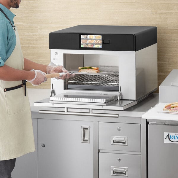 Chef putting a sandwich into a ventless oven