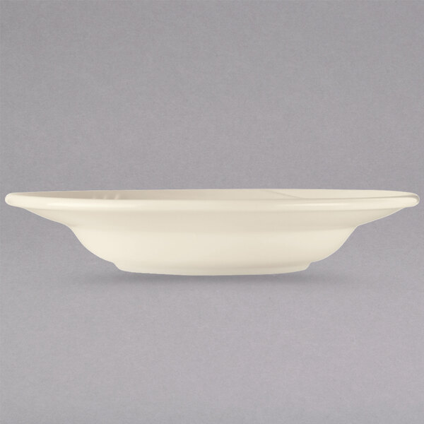A white bowl with a rim on a gray background.