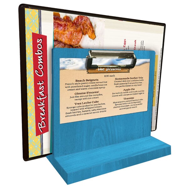 A blue wooden menu holder with a clipboard on a table holding a menu.