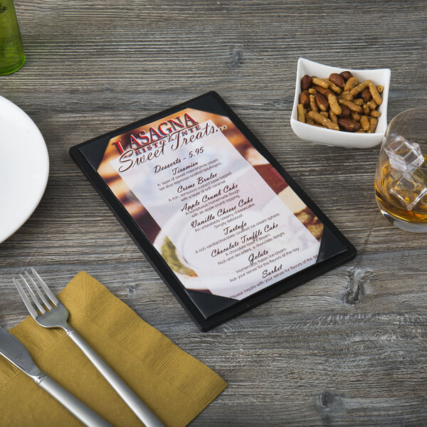 A Menu Solutions wood menu board with a picture of a pizza on a table.