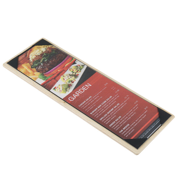 A Menu Solutions wood menu board with picture corners on a table with a plate of food.