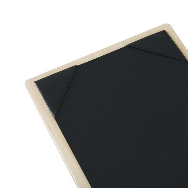 A natural wood menu board with black picture corners.