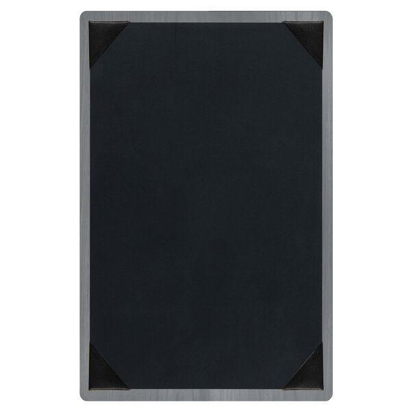 A customizable wood menu board with picture corners on a table.