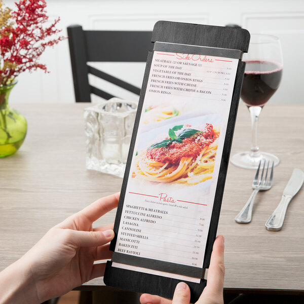 A person holding a black wood menu board with rubber band straps.