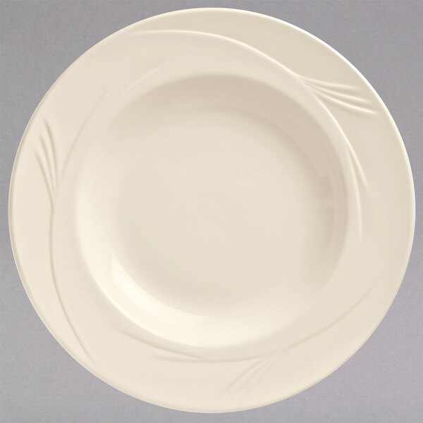 A Libbey cream white china pasta bowl with a swirl design on it.