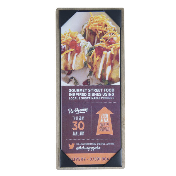 A rectangular wood menu board with top and bottom strips on a table with a customizable sign displaying food.