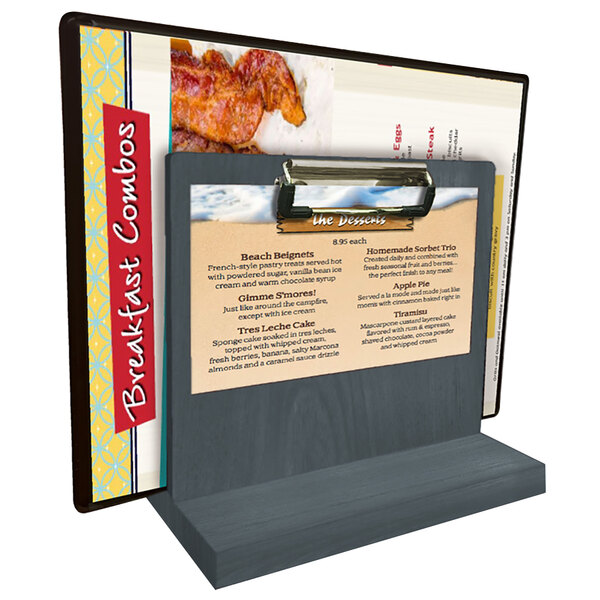 A Menu Solutions ash wood tabletop menu caddy with a clip holding a menu on a counter.
