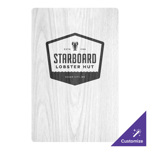 A white customizable wood menu board with picture corners on a table.