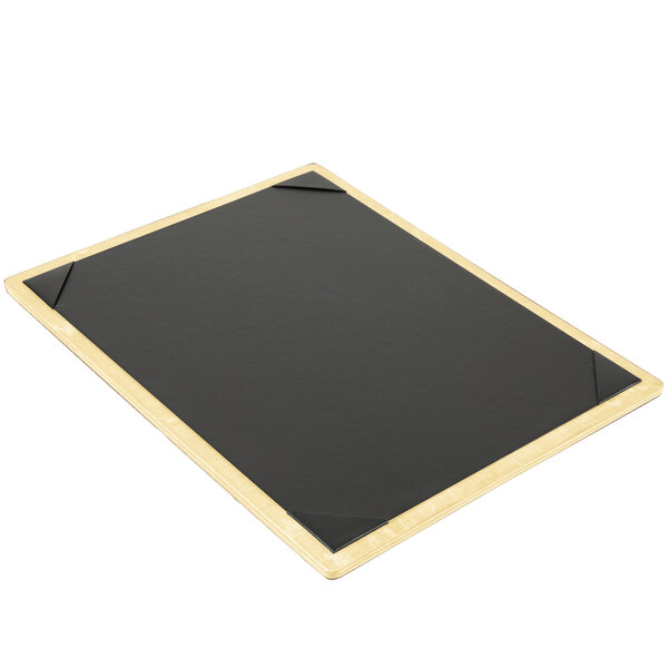 A wooden framed black board with gold picture corners.