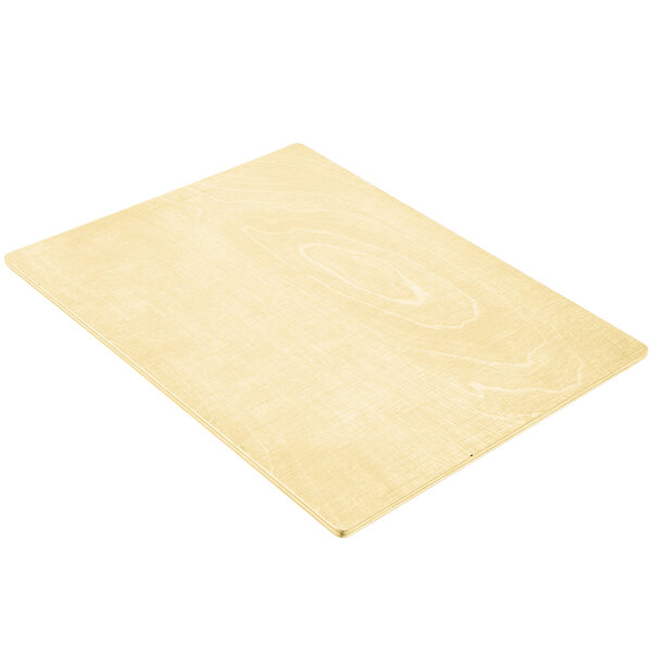 A close up of a natural wood surface with picture corners.