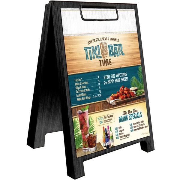 A black wood Menu Solutions sandwich menu board tent on a table.