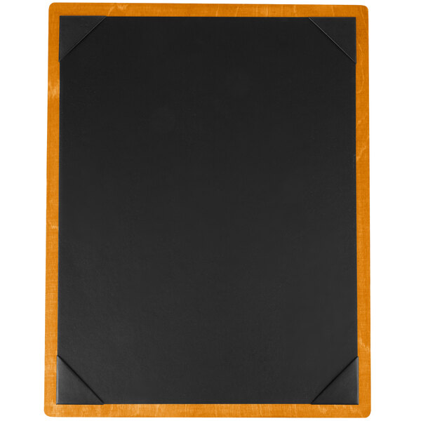 A black rectangular wood menu board with wooden corners on a wood surface.
